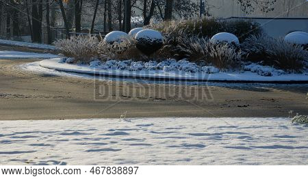 Roundabout Of Paving Gray Granite Cubes, Transport Hub, With Flowers And Grasses In The Middle Of Th