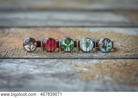 Close Up Handmade Rings With Flowers And Leaves Concept Photo. Craft Jewelry. Front View Photography