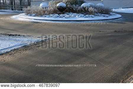 Roundabout Of Paving Gray Granite Cubes, Transport Hub, With Flowers And Grasses In The Middle Of Th