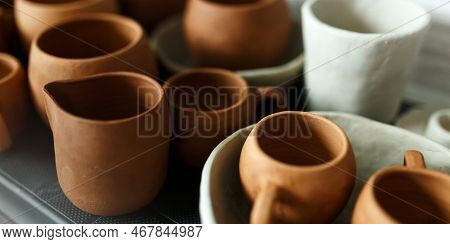 A Close-up Of Various Drying Clay Tableware On A Shelf. A Pottery Studio Concept. Craftmade Dishes, 