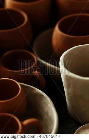 A Close-up Of Various Drying Clay Tableware On A Shelf. A Pottery Studio Concept. Craftmade Dishes, 