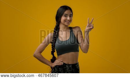 Happy Ethnic Indian Sport Woman Girl Lady Female Athlete In Yellow Studio Background Show Double Fin