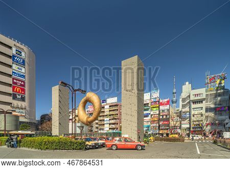 Tokyo, Japan - March 08 2022: Tokyo Skytree And Public Art Monument In Shape Of A Golden Comma-shape