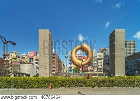 Tokyo, Japan - March 08 2022: Tokyo Skytree And Public Art Monument In Shape Of A Golden Comma-shape