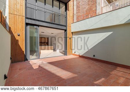 Residential Building On Several Floors With Sliding Doors Made Of Black Metal And Glass. Doorway Ope