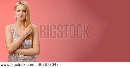 Jealous Displeased Angry Young Revengeful Blond Ex-girlfriend In Luxurious Silver Shiny Dress Frowni