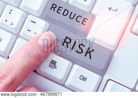 Hand Writing Sign Reduce Risk. Word For Lessen The Potential Damage That Could Be Caused By A Hazard