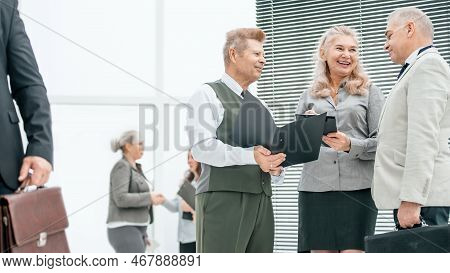 Close Up. Group Of Employees Discussing Documents Standing In The Office