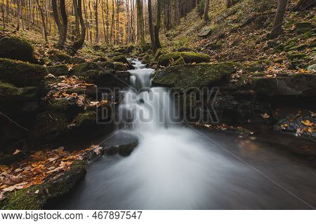 Vlasky River With Waterfall Illuminated With Sun In An Untouched Landscape In The Middle Of An Autum