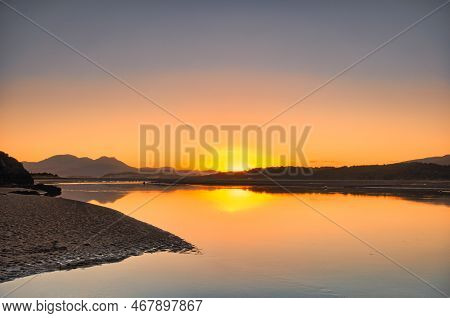 The Sun Rising Over The Ocean On An Autumn Morning.