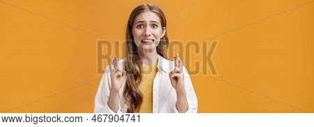 Girl Hopes She Did Well On Exam Clenching Teeth Looking Worried And Concerned, Crossing Fingers For 