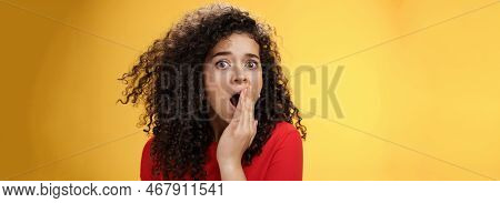 Close-up Shot Of Concerned And Shocked Worried Woman With Curly Hairstyle Open Mouth Wide And Coveri