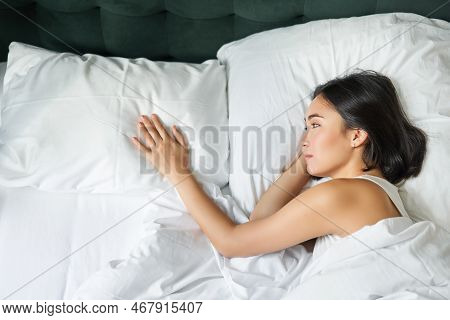 Portrait Of Romantic Asian Woman Lying Alone In Her Bed, Touching Empty Pillow And Thinking About He