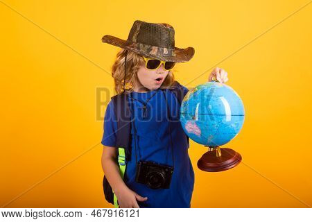 Child With Backpack And Camera, Explorer. Concept Of Exploration And Discovery. Kid Hold World Globe