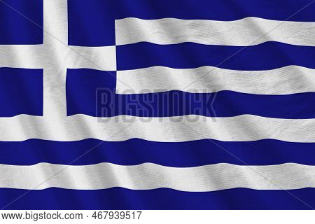 Greece Flag With Big Folds Waving Close Up Under The Studio Light Indoors. The Official Symbols And 