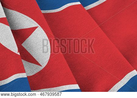 North Korea Flag With Big Folds Waving Close Up Under The Studio Light Indoors. The Official Symbols
