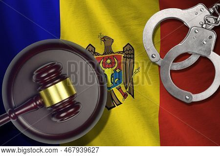 Moldova Flag With Judge Mallet And Handcuffs In Dark Room. Concept Of Criminal And Punishment, Backg