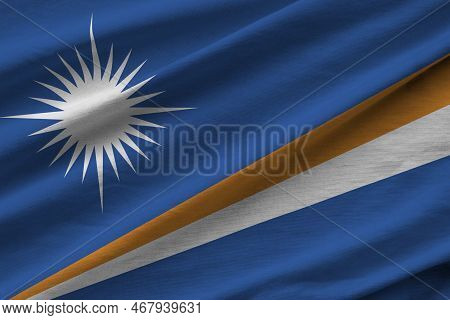 Marshall Islands Flag With Big Folds Waving Close Up Under The Studio Light Indoors. The Official Sy