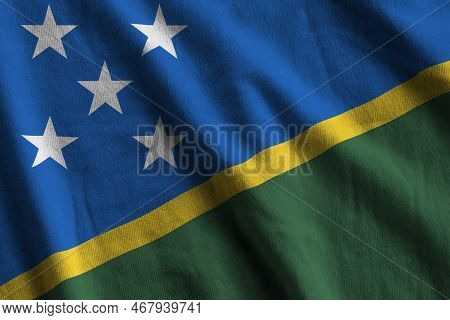 Solomon Islands Flag With Big Folds Waving Close Up Under The Studio Light Indoors. The Official Sym