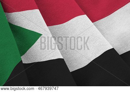 Sudan Flag With Big Folds Waving Close Up Under The Studio Light Indoors. The Official Symbols And C
