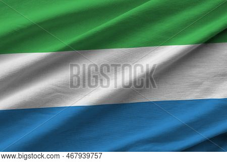 Sierra Leone Flag With Big Folds Waving Close Up Under The Studio Light Indoors. The Official Symbol