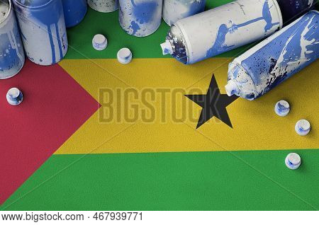 Sao Tome And Principe Flag And Few Used Aerosol Spray Cans For Graffiti Painting. Street Art Culture