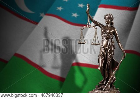 Uzbekistan Flag With Statue Of Lady Justice And Judicial Scales In Dark Room. Concept Of Judgement A