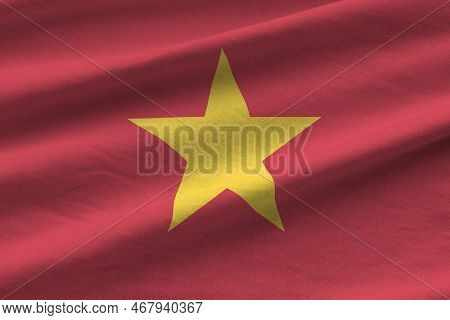 Vietnam Flag With Big Folds Waving Close Up Under The Studio Light Indoors. The Official Symbols And