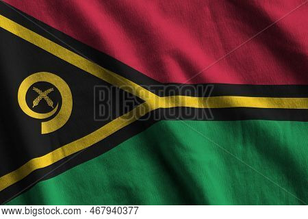 Vanuatu Flag With Big Folds Waving Close Up Under The Studio Light Indoors. The Official Symbols And