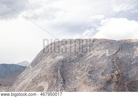 Petroglyphs On The Rocks In Kazakhstan. The Ancient Parking Cave Man. Historical Cave Paintings. Car