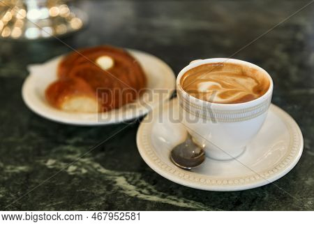 Cup Of Cappuccino And A Cornetto, Italian Croissant With Cream At Breakfast On A Counter At A Cafe I