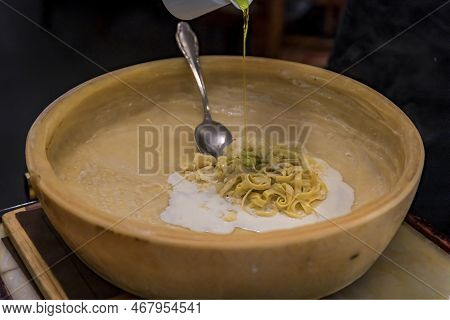 Fresh Cream, Olive Oil And Pasta In A Pecorino Cheese Wheel Cooked Tableside For Pasta Sauce At A Re