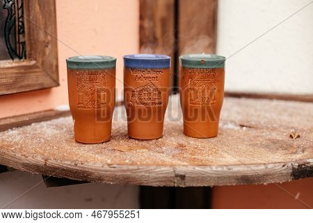 Dresden, Saxony, Germany, 10 December 2022: Clay Cups For Christmas Mulled Wine On Wooden Table In M