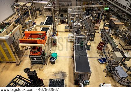 Production Of Cremant Sparkling Wine In Burgundy, France. Automatically Powered Bottling Lines On Fa