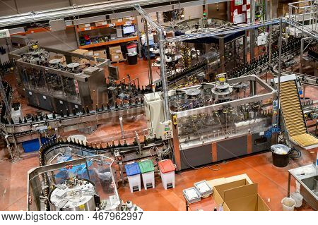 Production Of Cremant Sparkling Wine In Burgundy, France. Automatically Powered Bottling Lines On Fa