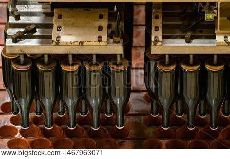 Production Of Cremant Sparkling Wine In Burgundy, France. Automatically Powered Bottling And Riddlin