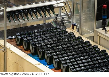 Production Of Cremant Sparkling Wine In Burgundy, France. Automatically Powered Bottling And Riddlin