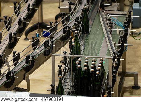 Production Of Cremant Sparkling Wine In Burgundy, France. Automatically Powered Bottling And Riddlin