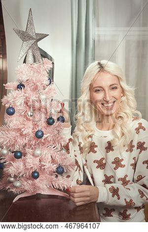 Pretty Blonde Lady Deecorating Christmas Tree At Home