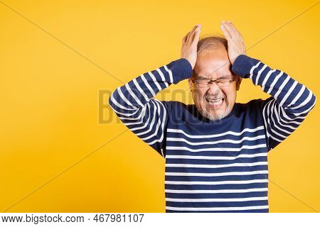 Portrait Senior Old Man Sad Suffering From Migraine Studio Shot Isolated On Yellow Background, Asian