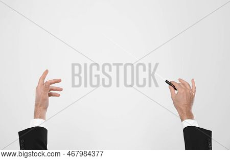 Professional Conductor With Baton On White Background, Closeup