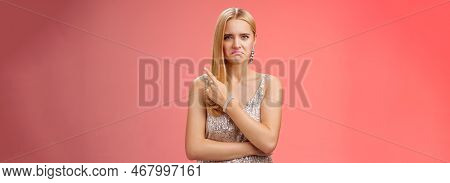 Jealous Displeased Angry Young Revengeful Blond Ex-girlfriend In Luxurious Silver Shiny Dress Frowni