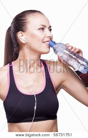 Fit Woman Drinking From Bottle During Training Exercise