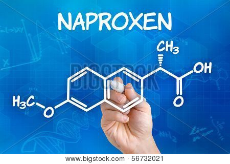 Hand with pen drawing the chemical formula of naproxen