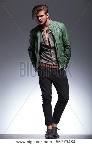 full body picture of a handsome man in leather jacket looking away to his side