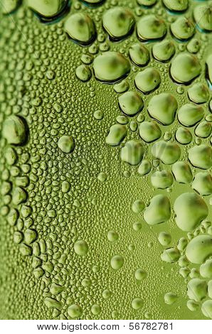Green glass with raindrops