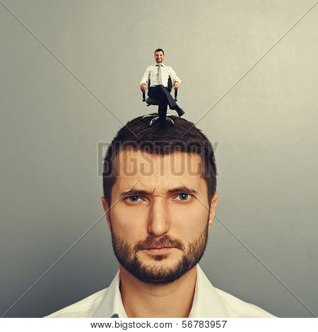 portrait of discontented man with happy man on the head