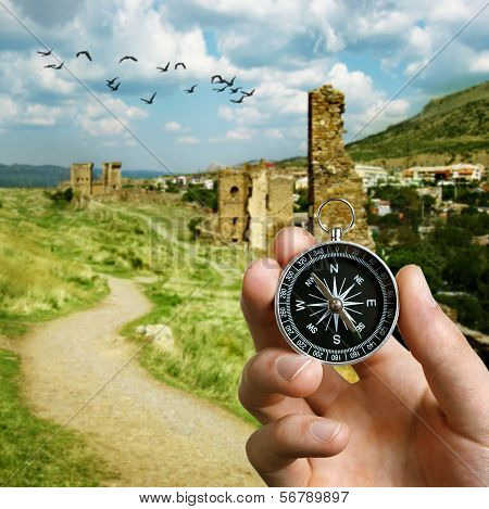 Man Using A Compass While Sightseeing Abroad