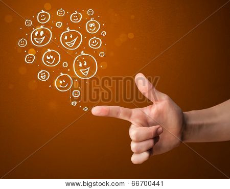 Group of happy hand drawed smiley faces coming out of gun shaped hands