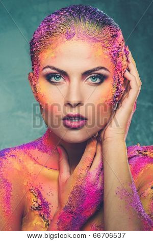 Beautiful young woman with conceptual colourful body art 